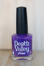 Load image into Gallery viewer, Purple nail polish bottle with black cap on a wooden surface