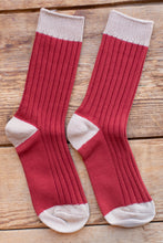 Load image into Gallery viewer, Red socks with white accents on a wooden surface
