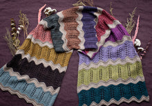 Load image into Gallery viewer, Colorful crocheted blanket with wavy pattern on a purple background
