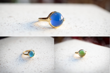 Load image into Gallery viewer, Gold ring with blue gemstone on a textured surface