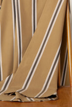Load image into Gallery viewer, Close-up of striped fabric with brown, beige, and black lines on a wooden surface.