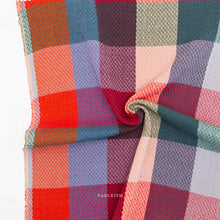 Load image into Gallery viewer, Multicolored checkered fabric with a brand name on a white background