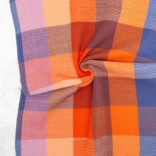 Load image into Gallery viewer, Close-up of a colorful checkered fabric with visible brand name.