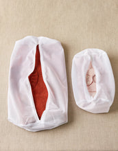 Load image into Gallery viewer, Two white mesh bags with red and pink items inside on a beige background