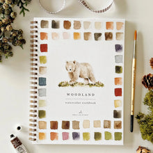 Load image into Gallery viewer, Woodland watercolor workbook with a bear illustration on a white surface with decorative items.