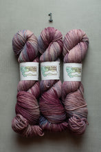 Load image into Gallery viewer, Three skeins of variegated yarn in shades of dusty purple, mauve, and pink, arranged vertically on a neutral gray background with a small number '1' above them. The labels read Great Falls Yarns.
