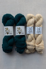 Load image into Gallery viewer, Four skeins of yarn arranged side by side on a light beige textured fabric background. The left two skeins are a deep teal green, and the right two skeins are a warm cream beige.