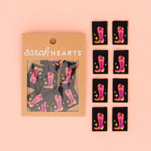 Load image into Gallery viewer, Packaging of pink cowboy boot stickers with &#39;sarah HEARTS&#39; branding on a pink background