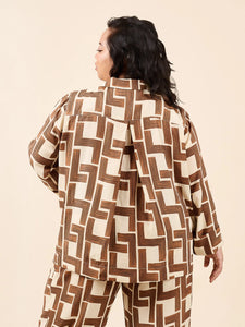 Person wearing a brown and beige geometric patterned outfit on a beige background