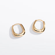 Gold hoop earrings on a white background