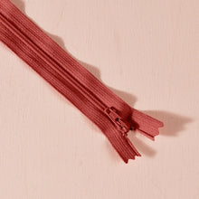 Load image into Gallery viewer, Red zipper on a pink background