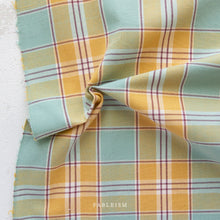 Load image into Gallery viewer, Plaid fabric with yellow, green, and red pattern on a white background, branded 'Fableism'.