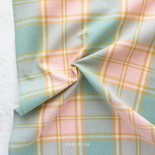 Load image into Gallery viewer, Pastel plaid fabric with a visible brand name on a light background