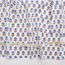 Load image into Gallery viewer, Floral patterned fabric with 'Fableism' branding on a white background