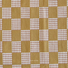 Load image into Gallery viewer, Checkered pattern with brown and white squares on a fabric background