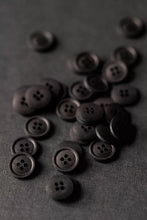 Load image into Gallery viewer, Dark brown buttons scattered on a dark gray background