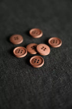 Load image into Gallery viewer, Brown buttons on a textured black surface