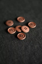 Load image into Gallery viewer, Brown buttons on a textured black surface