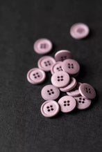 Load image into Gallery viewer, Purple buttons scattered on a black background