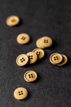 Load image into Gallery viewer, Wooden buttons scattered on a dark fabric background