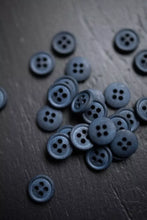 Load image into Gallery viewer, Collection of dark blue buttons on a wooden surface