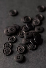 Load image into Gallery viewer, Dark brown buttons scattered on a dark gray background