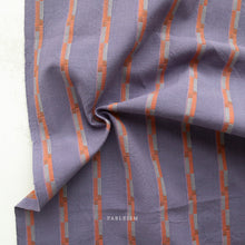 Load image into Gallery viewer, Purple fabric with orange and gray striped pattern, branded 'Fableism'.