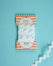 Load image into Gallery viewer, Packaged ribbon with striped design on a light blue background