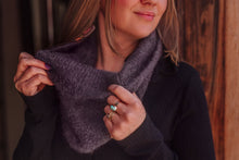 Load image into Gallery viewer, Woman adjusting a dark purple scarf against a wooden background