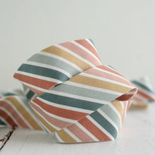 Load image into Gallery viewer, Colorful striped fabric knot on a light background