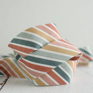 Colorful striped fabric knot on a light background
