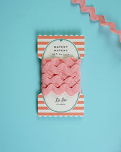 Load image into Gallery viewer, Pack of pink yarn with a striped label on a light blue background