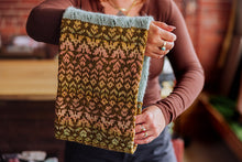 Load image into Gallery viewer, Person holding a knitted fabric with a pattern, blurred background