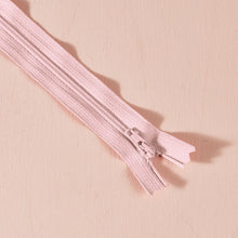 Load image into Gallery viewer, Pink zipper on a beige background