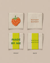 Load image into Gallery viewer, Two fabric swatches with a strawberry design and text on a beige background