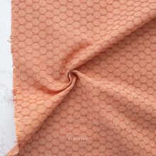 Load image into Gallery viewer, Close-up of pink textured fabric with 'Fableism' branding.