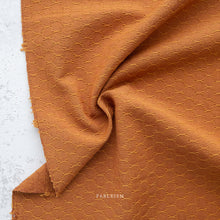 Load image into Gallery viewer, Brown textured fabric with a subtle pattern on a light gray background, featuring the brand 'Tableism'.