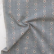 Load image into Gallery viewer, Gray fabric with floral patterns on a textured surface