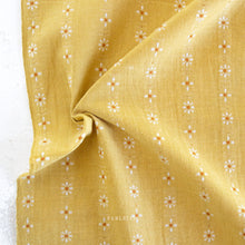 Load image into Gallery viewer, Yellow fabric with small floral patterns on a white background