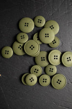 Load image into Gallery viewer, Green buttons scattered on a dark surface