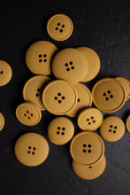 Load image into Gallery viewer, Yellow buttons with four holes on a dark background