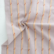 Striped fabric with a subtle pattern on a light gray background