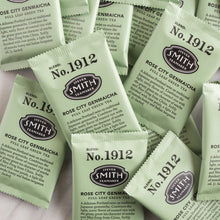 Load image into Gallery viewer, Multiple packets of Steven Smith Tea Teamaker Rose City Genmaicha green tea on a light background.