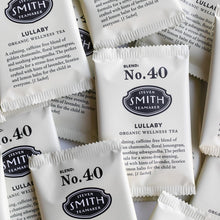 Load image into Gallery viewer, Multiple packets of Steven Smith Teamaker organic wellness tea with branding and product details.