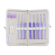 Set of purple crochet hooks in a beige case on a white background