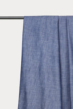 Load image into Gallery viewer, A close-up of a blue textured curtain panel hanging from a black metal rod against a plain off-white background.