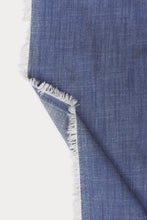 Load image into Gallery viewer, A close-up of a blue woven textile with frayed white edges, folded over against a plain white background.