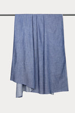 Load image into Gallery viewer, A blue textured linen or cotton skirt draped over a black metal clothing rack against a plain off-white background.