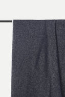 A close-up of dark charcoal gray fabric draped over a black metal rod against a plain white background.