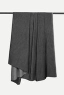A dark gray draped fabric, likely a scarf or wrap, hanging from a black metal rod against a plain white background.